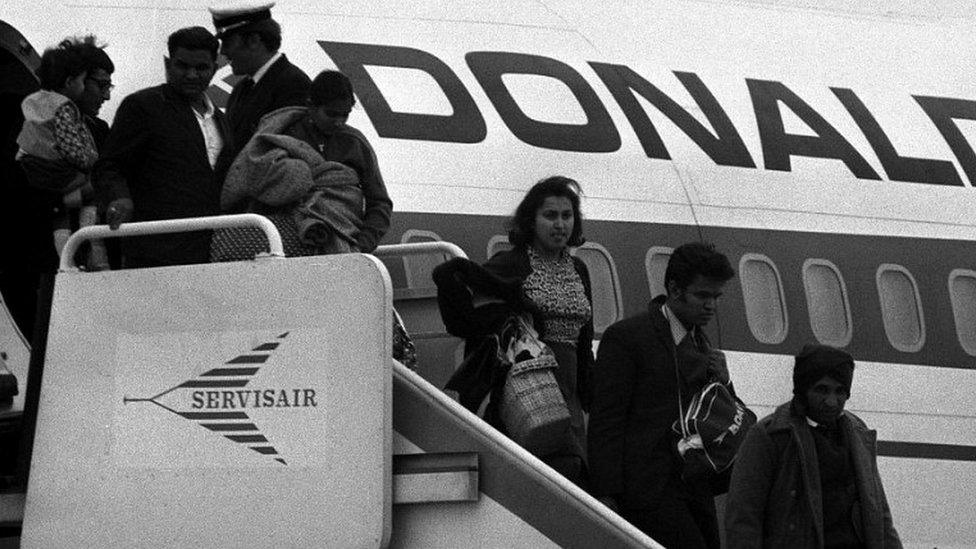 Passengers disembark from a specially chartered aircraft bringing the first group of Ugandan Asians to the UK