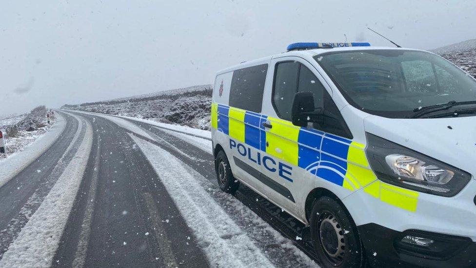 Snowy road at the Sloc with a police van