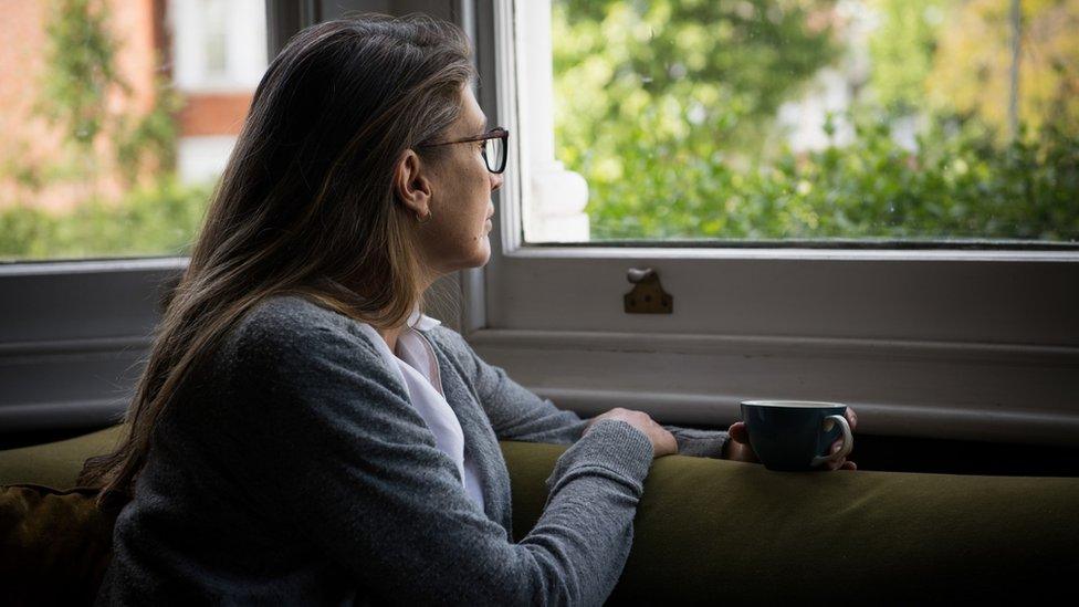 Woman looking out of window