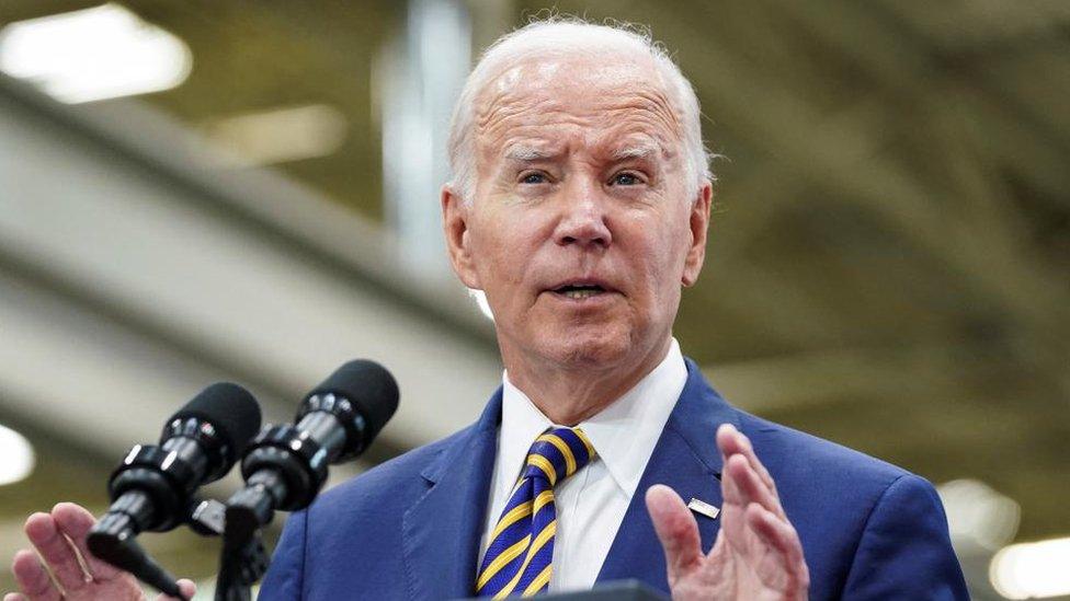 President Biden speaks from a podium during a visit to an engineering facility in Milwaukee