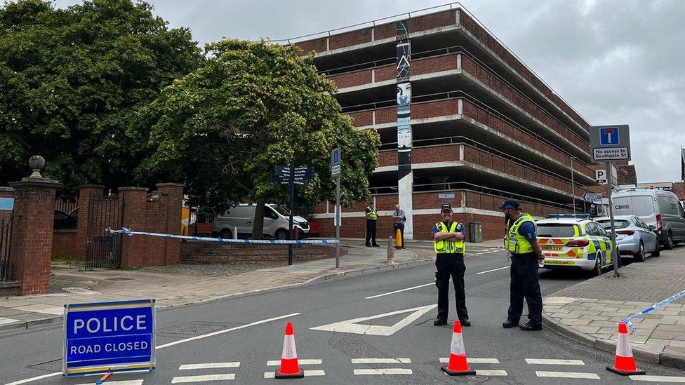 Two police officers and a road closed sign in Gloucester