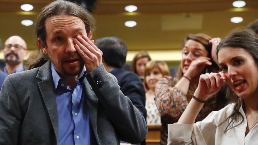 Podemos leader Pablo Iglesias and party member Irene Montero crying