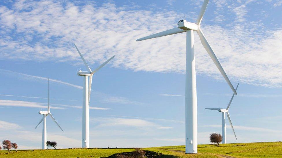 A wind farm on the outskirts of the Lake District with Skiddaw behind, Cumbria