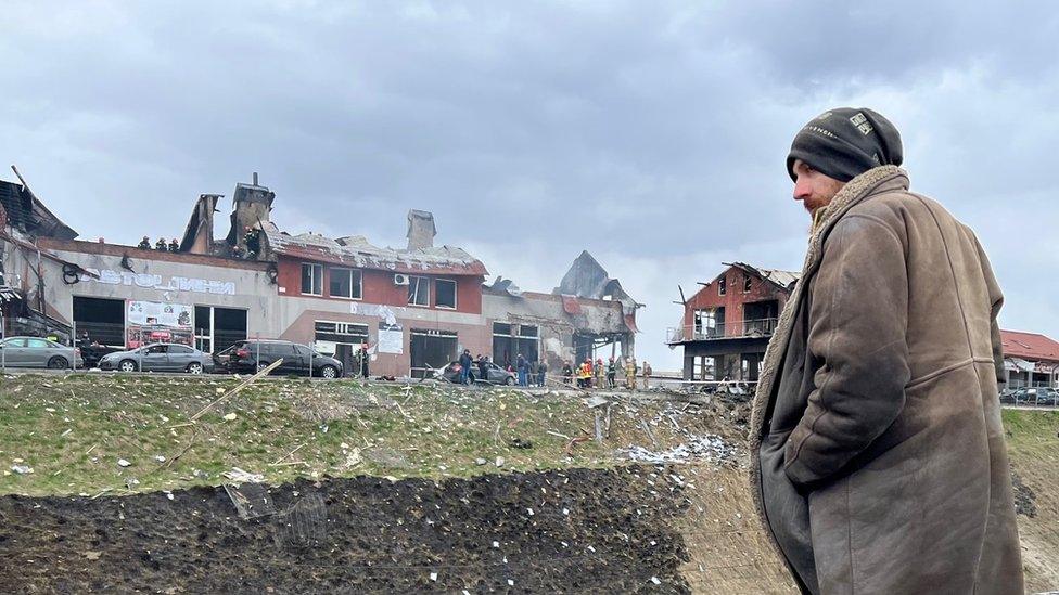 A man looks at the site of a Russian attack in Lviv