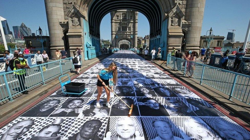 The faces of more than 1,000 Londoners pasted along the road at Tower Bridge