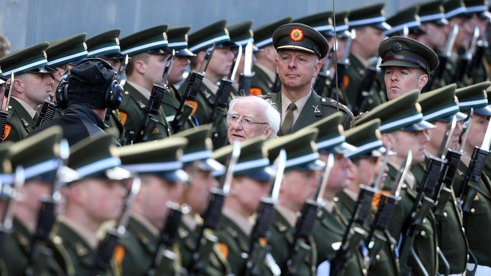 President Michael D Higgins inspects the guard of honour at the GPO