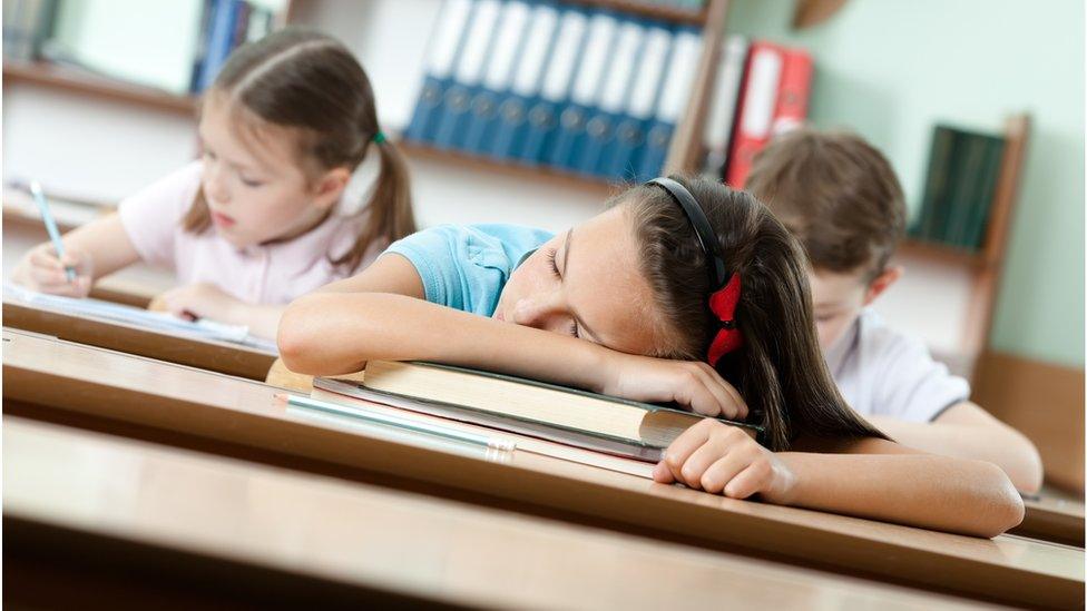 Pupil asleep on desk