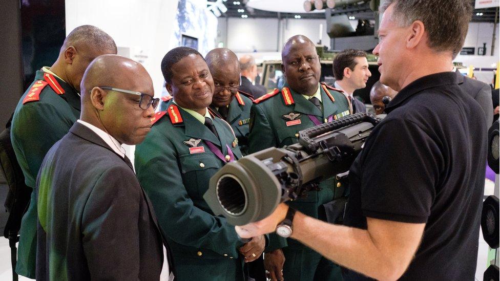 A group from the Botswana military are shown weapons by the SAAB team