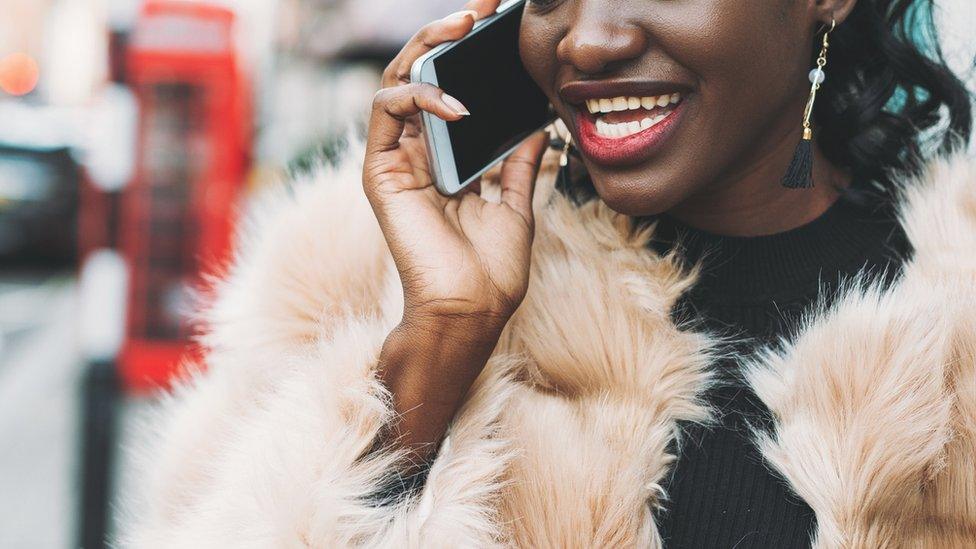 A woman using a smartphone in the street