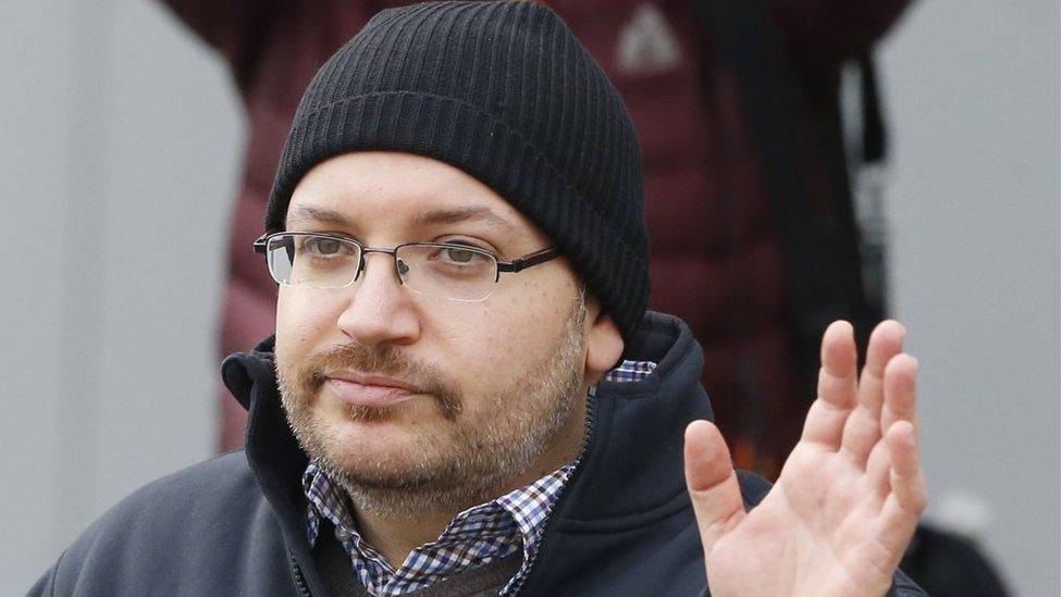 Journalist Jason Rezaian waves as he poses for journalists in front of Landstuhl Regional Medical Center in Landstuhl, Germany on 20 January, 2016 after being released from prison in Iran