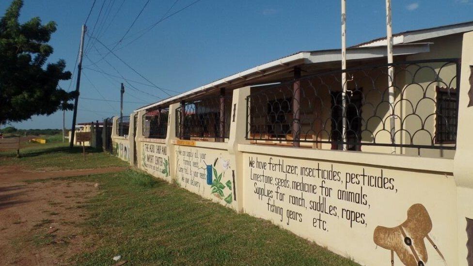 A shop advertises fertilizers on its wall