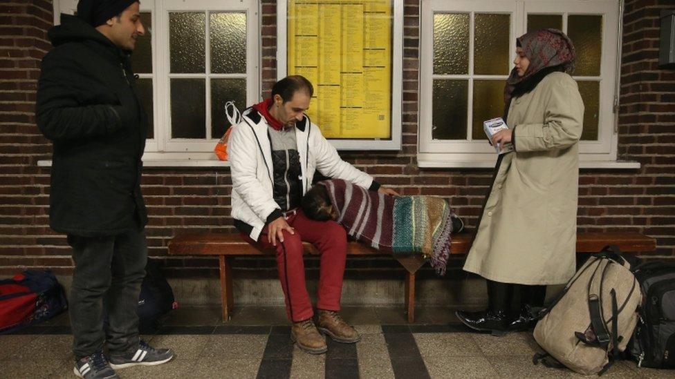 Refugees from Syria hoping to receive asylum in Denmark wait for a train in a train station near the Danish border on 6 January 2016 in Flensburg, Germany