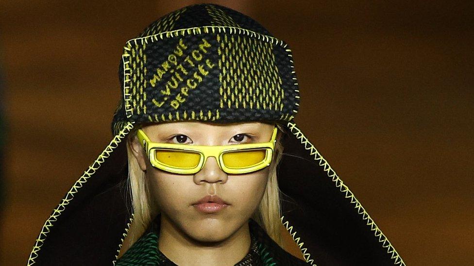 A model shows off items from Pharrell's spring/summer 2024 collection