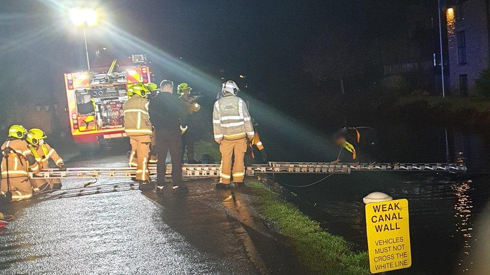 Man being saved from canal