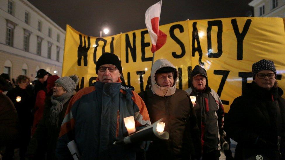 People hold candlelit demonstration against judicial reforms near the Presidential Palace in Warsaw, Poland December 14, 2017