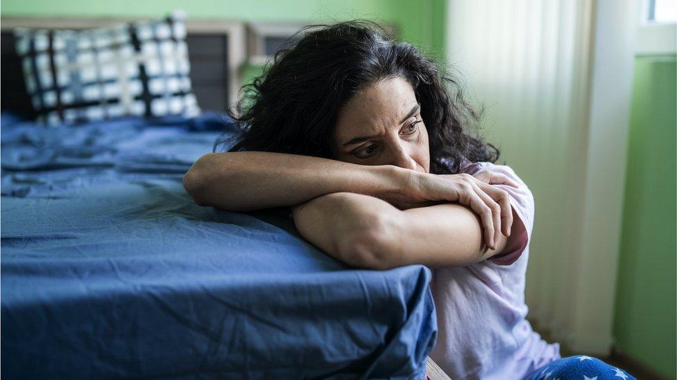 image of lady next to bed