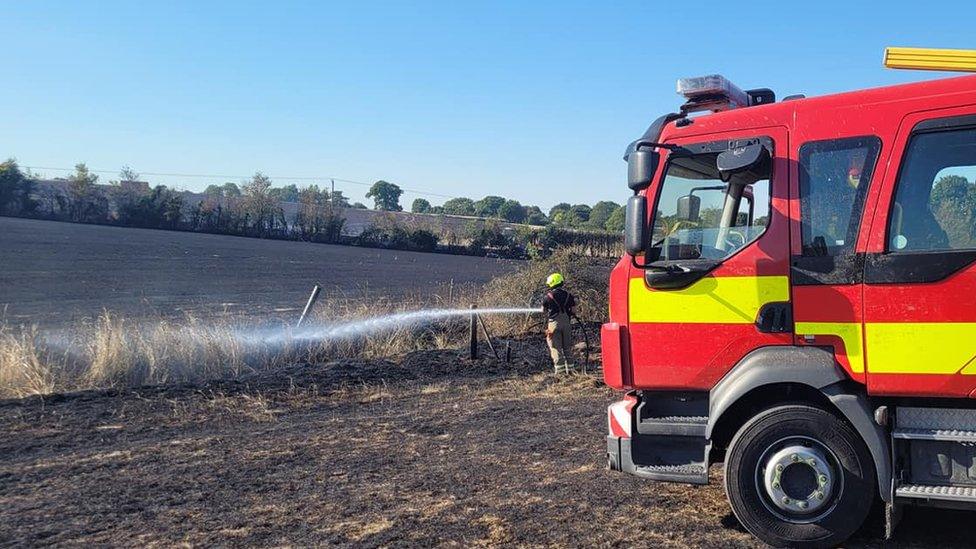 A firefighter putting out a fire in Sudbury, Suffolk