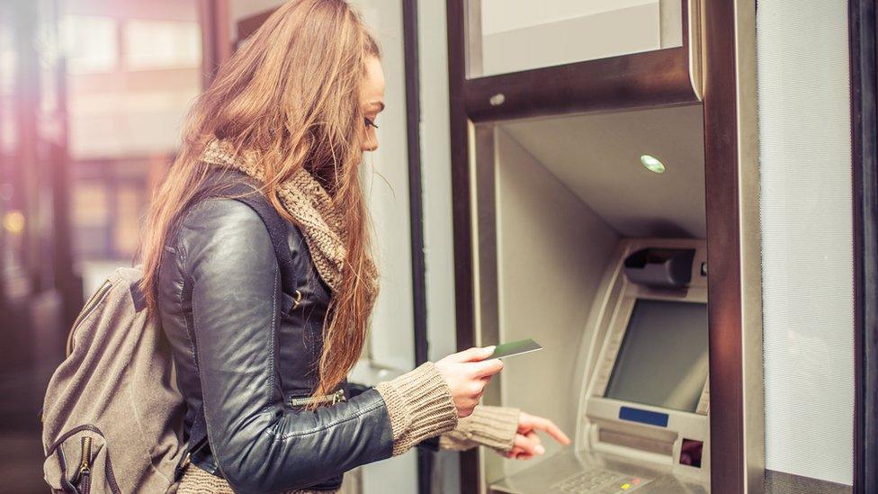 woman at cash machine