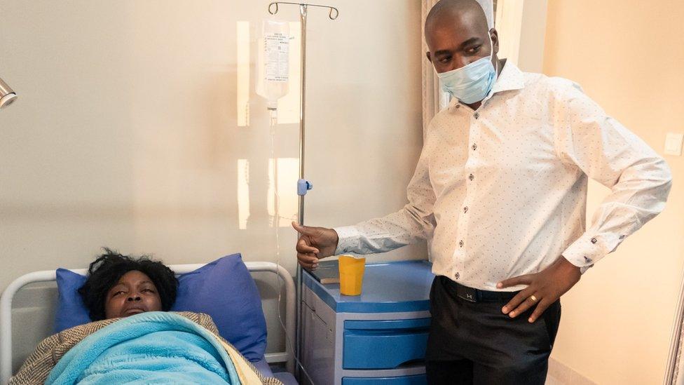 Zimbabwean opposition party leader Nelson Chamisa (R) stands next to Cecilia Chimbiri (L)