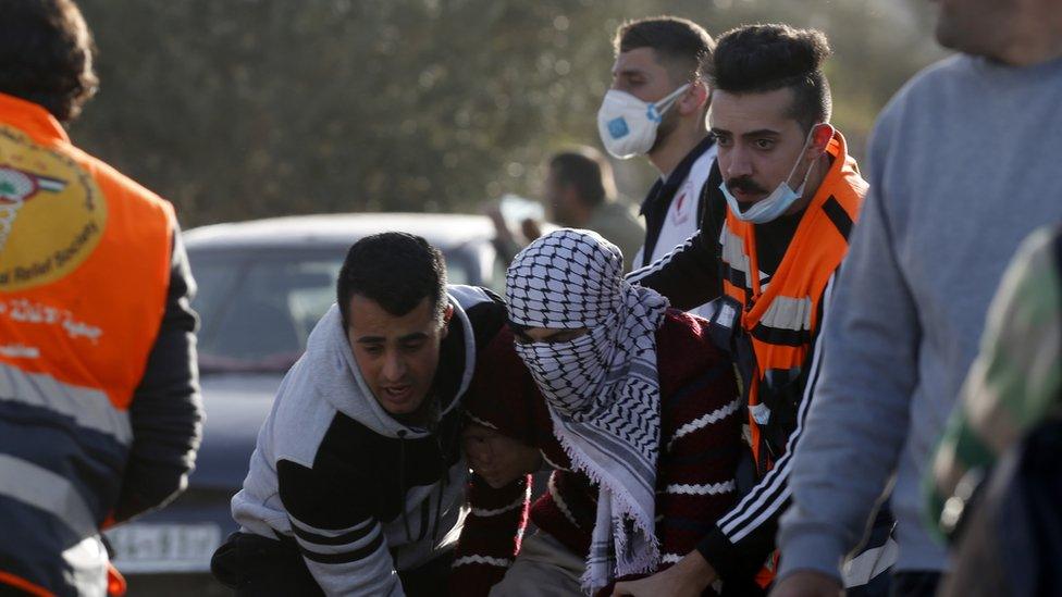 Palestinians evacuate a wounded protester during clashes with Israeli forces near Beita, in the occupied West Bank (11 March 2020)