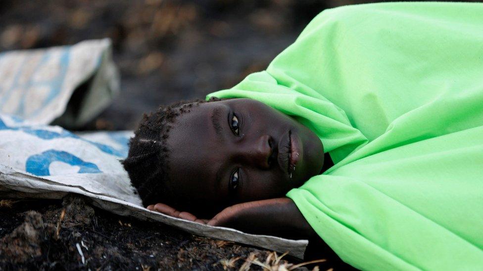 A woman waits to be registered