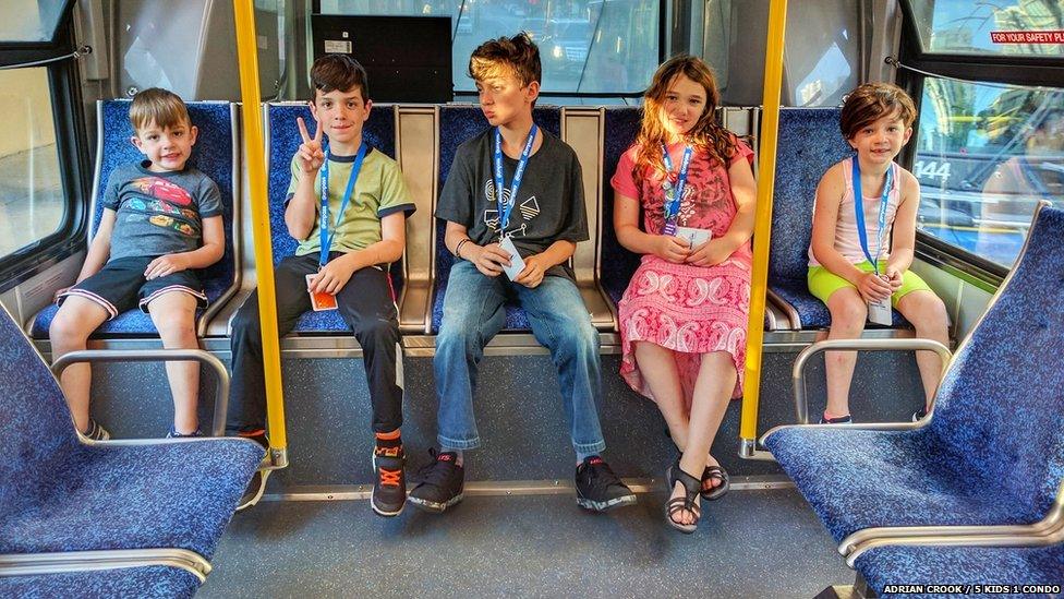 Adrian Crook's children, ages 5-11, taking the bus