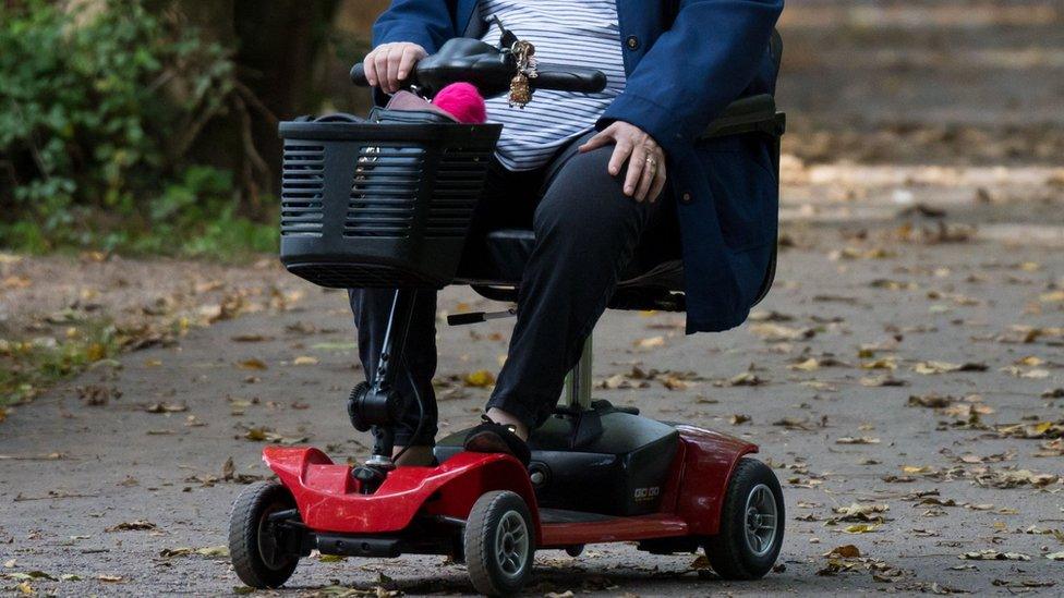 Woman in mobility scooter