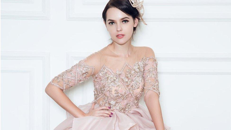 A model wearing a rose gold gown