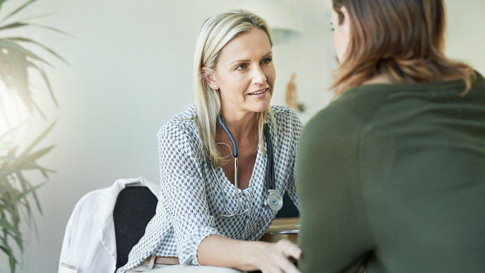 A doctor talking to her patient