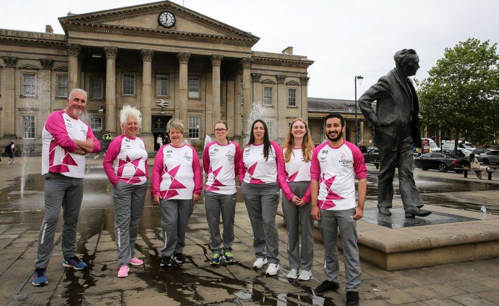 Batonbearers Graham Boanas, Christa Minns, Julia Jones, Rachael Bradley, Charlene Novak, Cathy Watts and Zakaria Rob at the Birmingham 2022 Queen's Baton Relay visit to Huddersfield