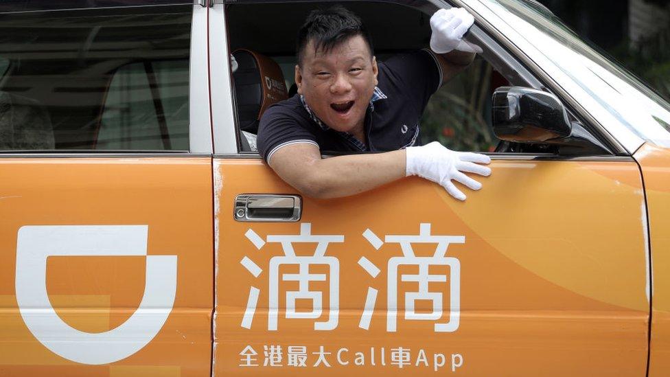 Ng Shu-kei, City Manager of Didi Chuxing Hong Kong, poses in a taxi at Jordan.