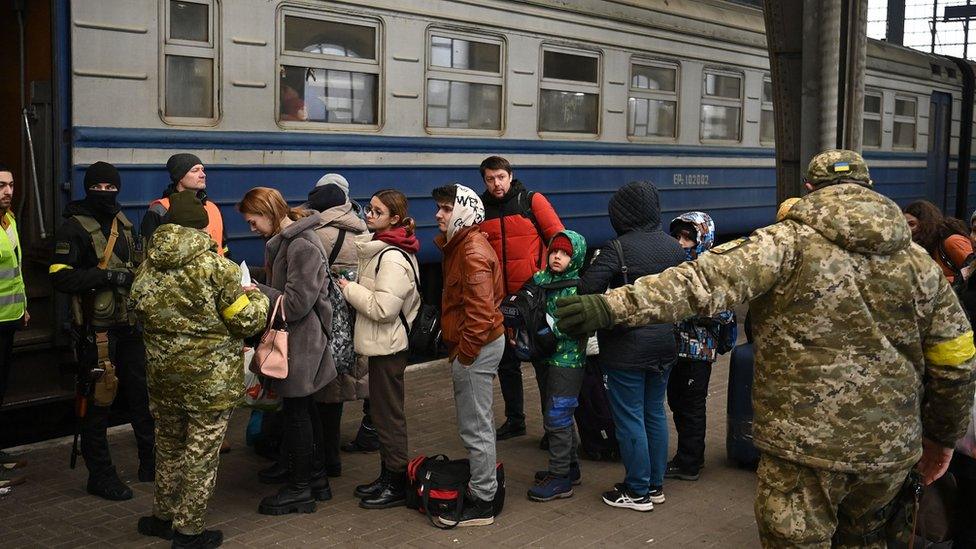 Refugees board train to Poland