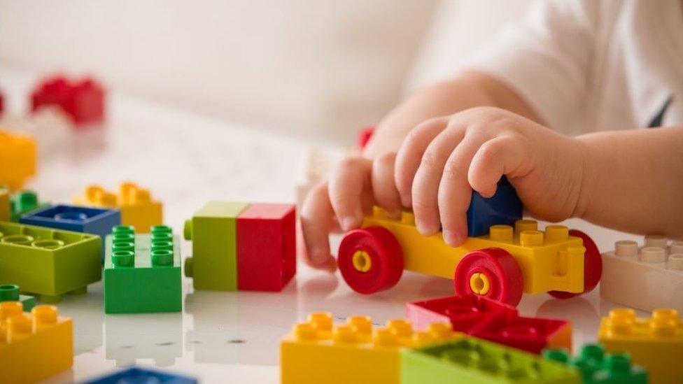 Child's hands with plastic toys