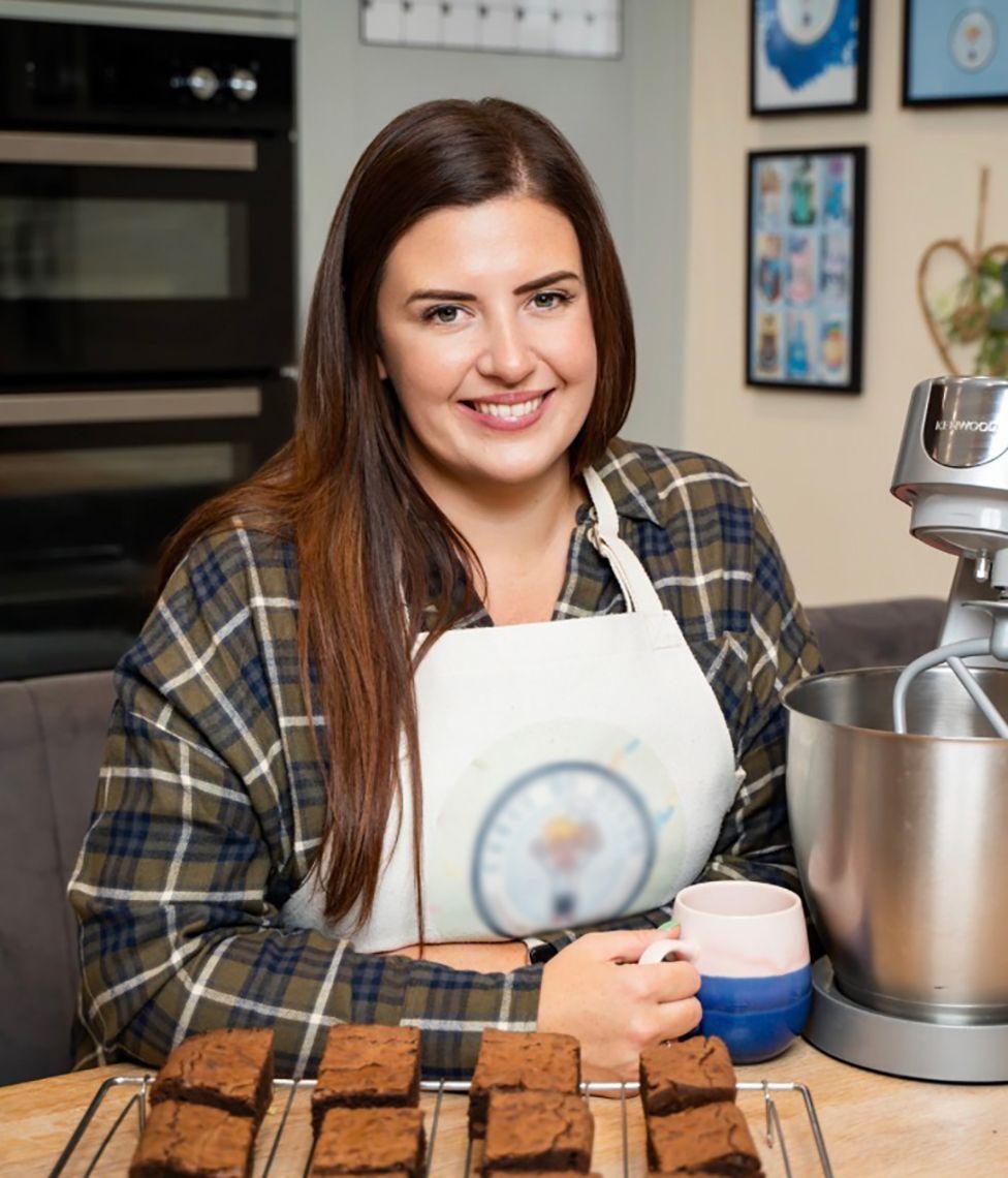 A photo of Charlotte, a woman with long, brown hair which she wears straight and with a side parting