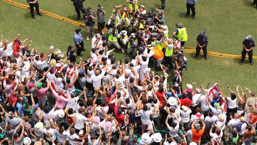 England cricketers celebrate with the Barmy Army after winning