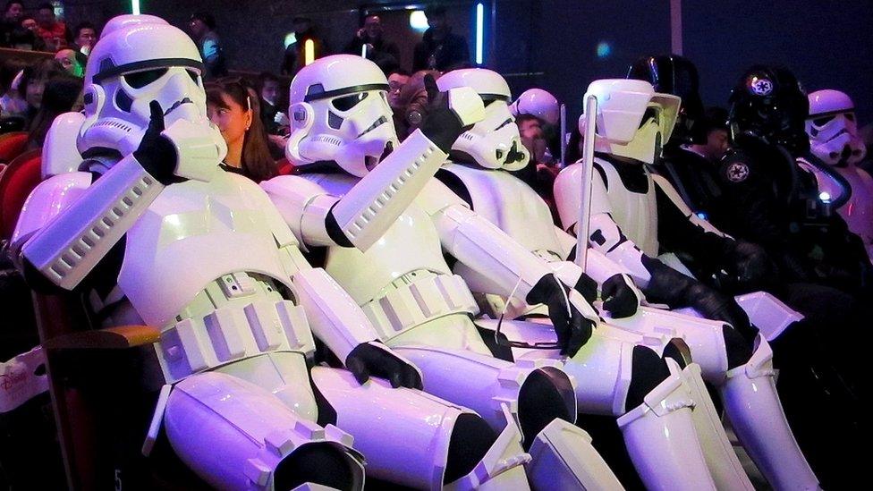 Movie fans dressed at Stormtroopers, seated in a cinema in China