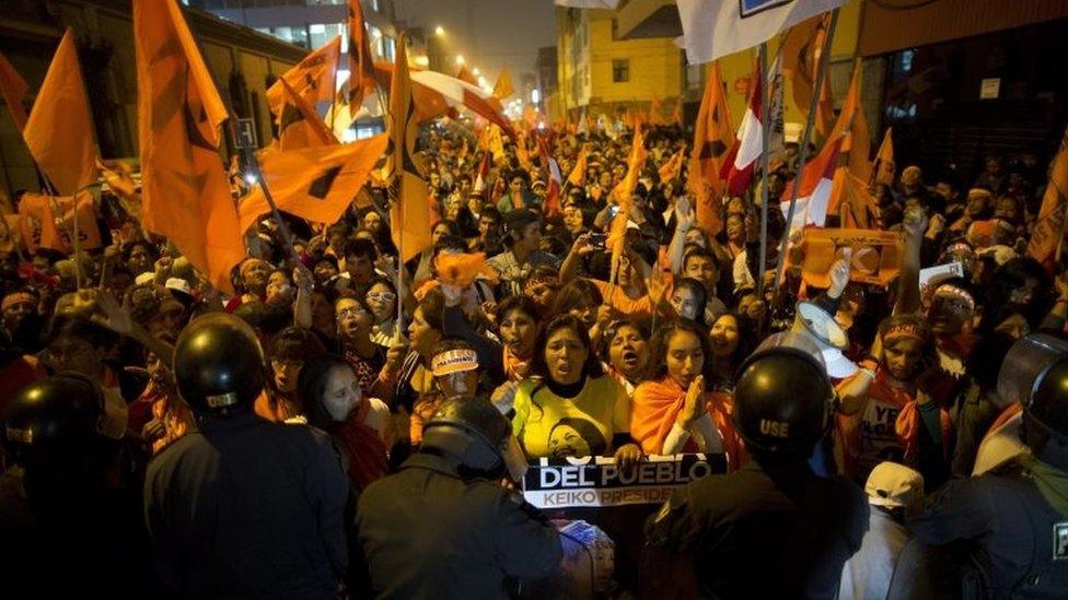 Supporters of presidential candidate Keiko Fujimori chant slogans against her rival Pedro Pablo Kuczynski outside the National Office of Electoral Processes in Lima, Peru, Tuesday, June 7, 2016