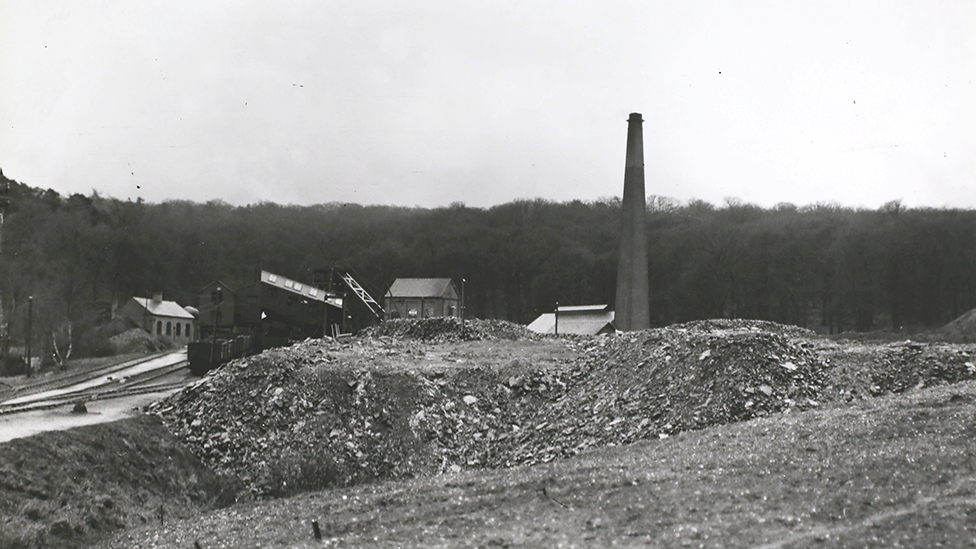 Black and white image of Brereton Colliery taken in 1908. Behind spoil heaps in the foreground are the colliery buildings, including a large chimney to the right