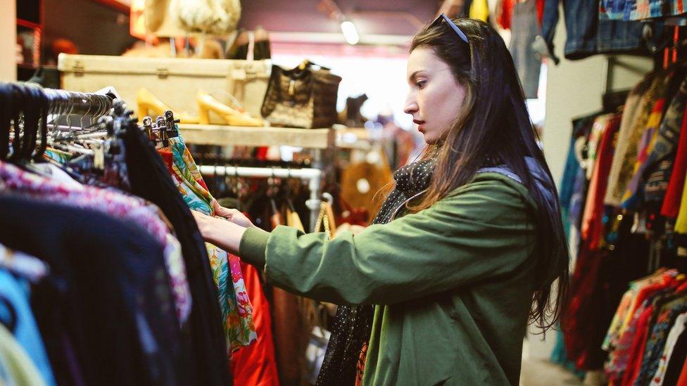 Woman in a second-hand clothes shop