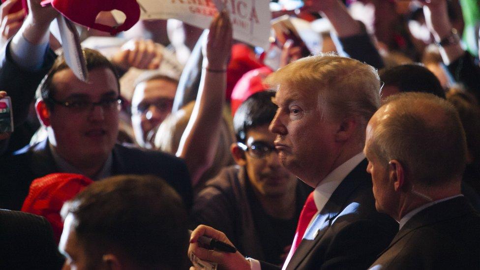 Republican presidential candidate Donald Trump greets the crowd after speaking to supporters at a campaign stop