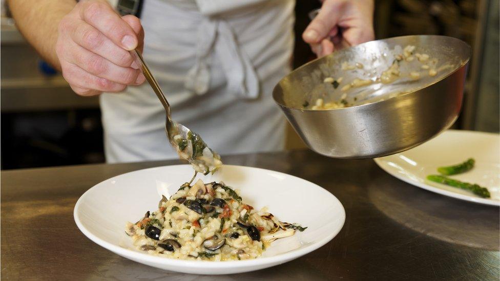 Dish of risotto being dished up in a restaurant