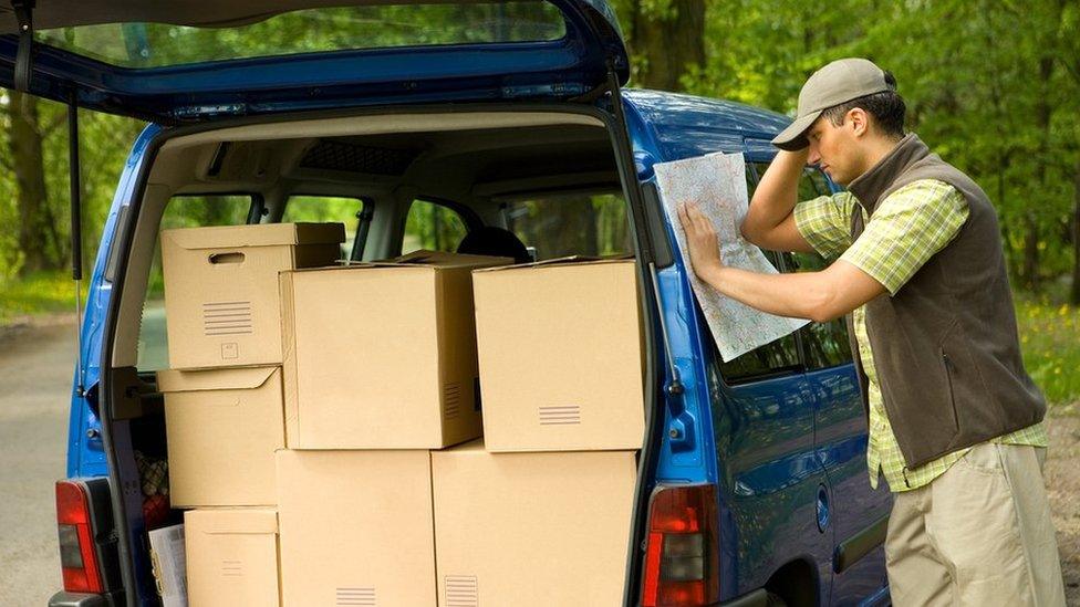 Delivery driver looking at map