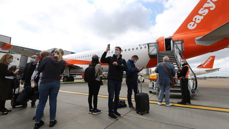 Passengers prepare to board an easyJet flight