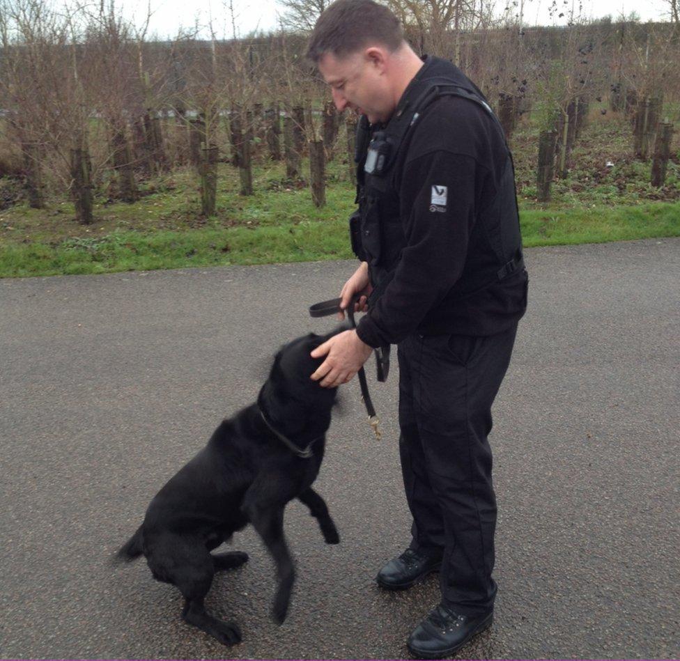 Ozzy the police dog with handler PC Paul Huggett