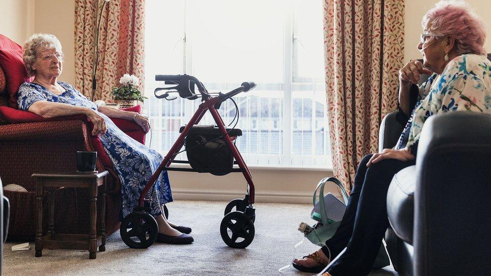 Two women chatting in a care home