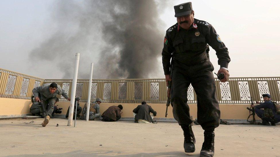 Afghan police take position during siege in Jalalabad on 24 January 2018