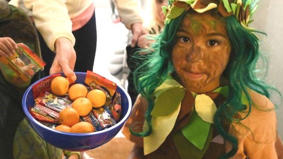 Children going trick-or-treating in London.