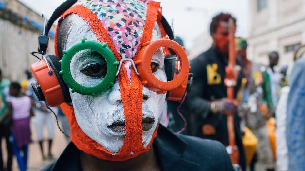 A man wearing a homemade mask using the theme "Africa Electronics" as his inspiration