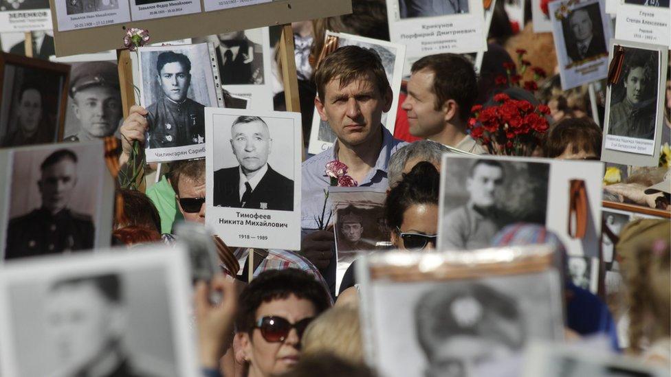 Participiants hold pictures of WW II soldiers in the Immortal Regiment march during the Victory Day celebration in Riga, Latvia, 09 May 2016. EPA/VALDA KALNINA