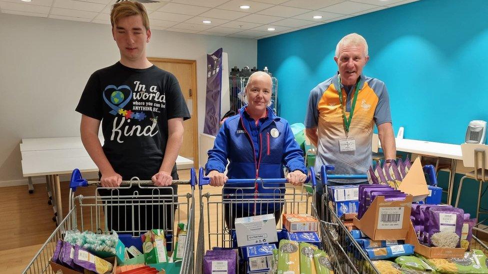 Sebbie Hall buying food to donate to a food bank